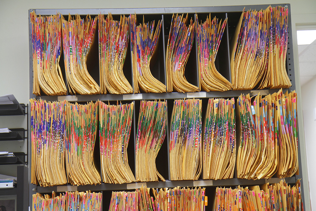 A file cabinet with color coded folders is seen in a doctor's office. (Getty/Jeffrey Greenberg/Universal Images Group)