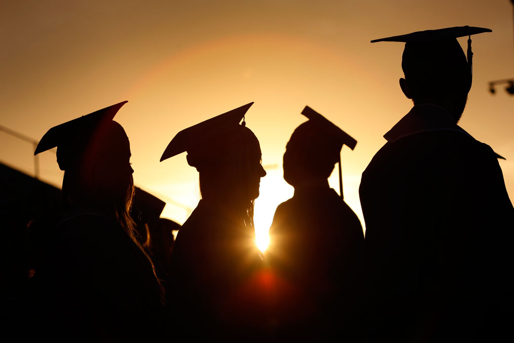 Students line up to receive their diplomas during a graduation ceremony at sunset in Santa Monica, California, June 2013. (Getty/Los Angeles Times/Allen J. Schaben)
