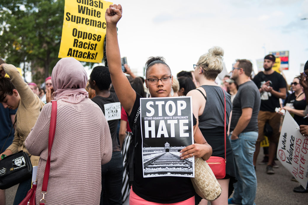 A woman raises her fist during a march in Minneapolis protesting white supremacist violence, August 14, 2017. (Getty/Stephen Maturen)