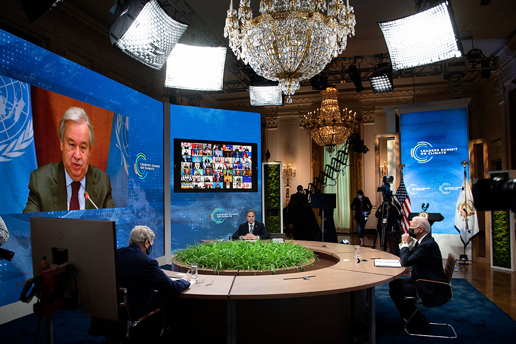 From left to right: Special Presidential Envoy for Climate John Kerry, Secretary of State Antony Blinken, and President Joe Biden listen as U.N. Secretary-General António Guterres speaks onscreen during a climate change virtual summit from the East Room of the White House campus, April 22, 2021, in Washington. (Getty/Brendan Smialowski/AFP)