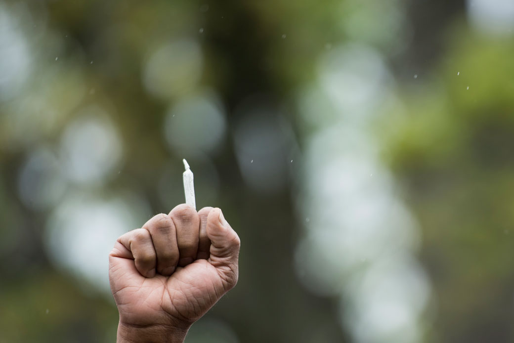 A man holds a marijuana joint during a protest in front of the U.S. Capitol in April 2017, Washington, D.C. (Getty/Bill Clark)