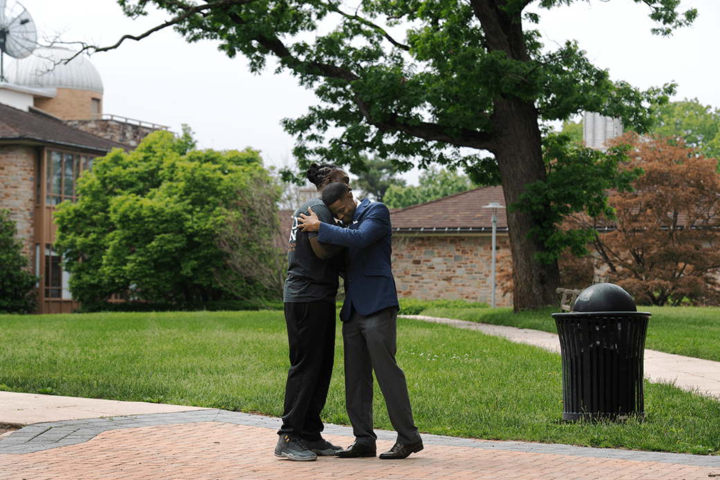 Donte Small embraces his former cellmate Sanford Barber in Towson, Maryland, May 2018. Both men participated in the Goucher Prison Education Partnership, which provides men and women incarcerated in Maryland with the opportunity to pursue a college education. (Getty/Marvin Joseph/The Washington Post)