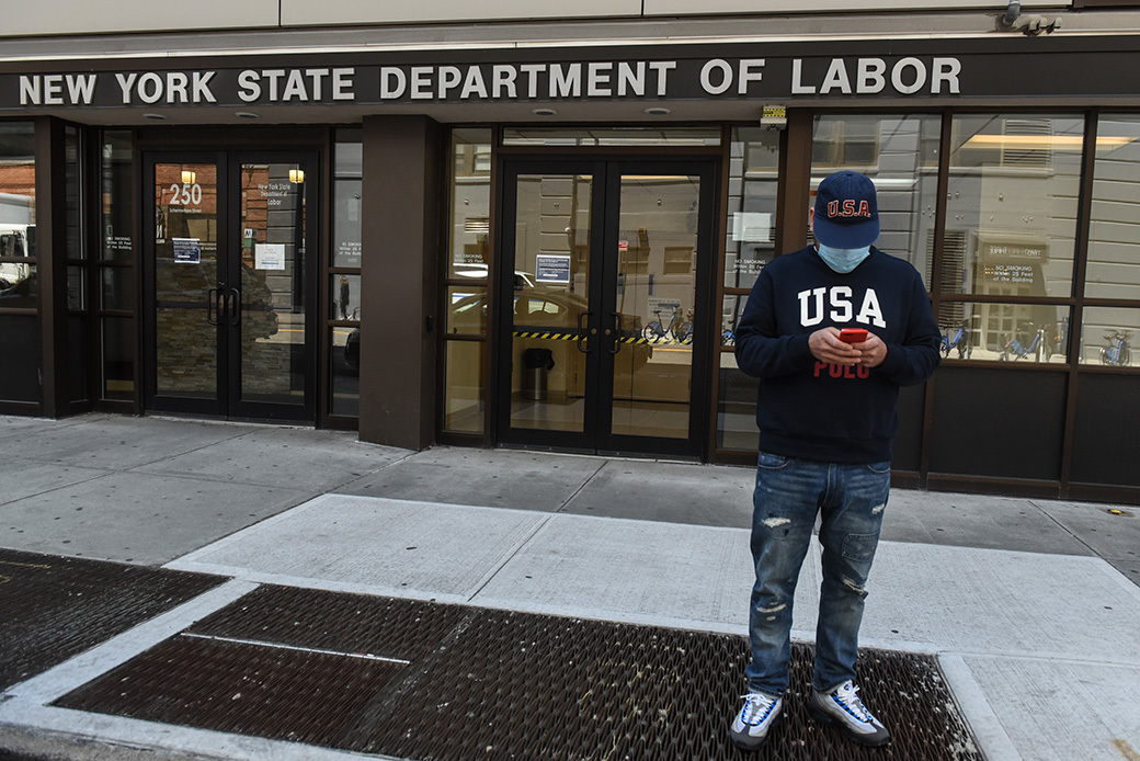 A man stands in front of the closed offices of the New York State Department of Labor in Brooklyn, New York, on May 7, 2020. (Getty/Stephanie Keith)