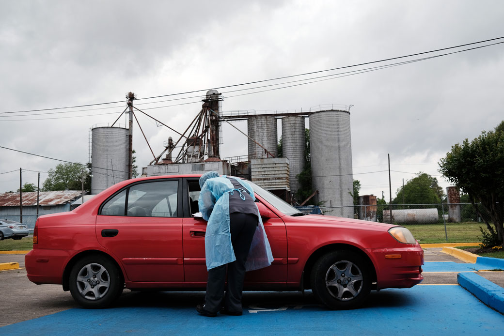  (Medical workers prepare to vaccinate people at a pop-up COVID-19 vaccination clinic in a rural Delta community in Leland, Mississippi, April 2021.)