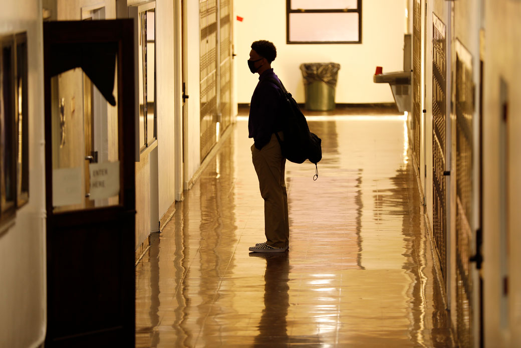  (A high school freshman returns to campus for the first time since schools closed due to the coronavirus, as students return for in-person instruction at a high school in Long Beach, California, March 2021.)