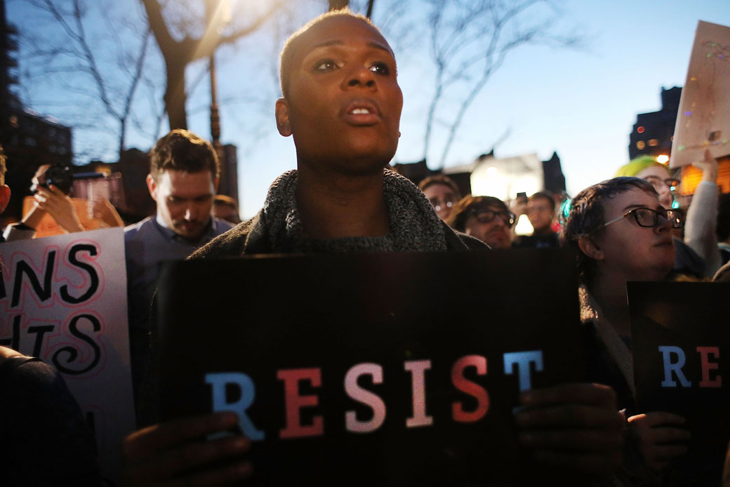 A protestor holds a “Resist” sign at a rally in support of transgender people at the Stonewall Inn in New York City, February 2017. (Getty/Spencer Platt)