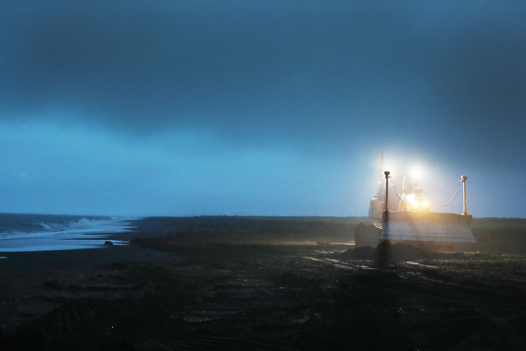 A bulldozer is used to push dirt into place in an attempt to widen the beach area and protect the village airstrip from coastal erosion due to the waves of the Chukchi Sea in Kivalina, Alaska, September 2019. (Getty/Joe Raedle)