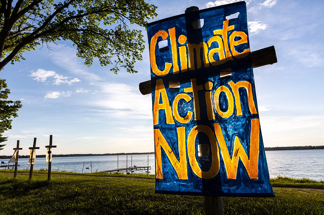 Calls for climate action and Line 3 pipeline protest signs are seen during a faith gathering and prayer circle in Minnesota, June 2021. (Getty/Kerem Yucel/AFP)