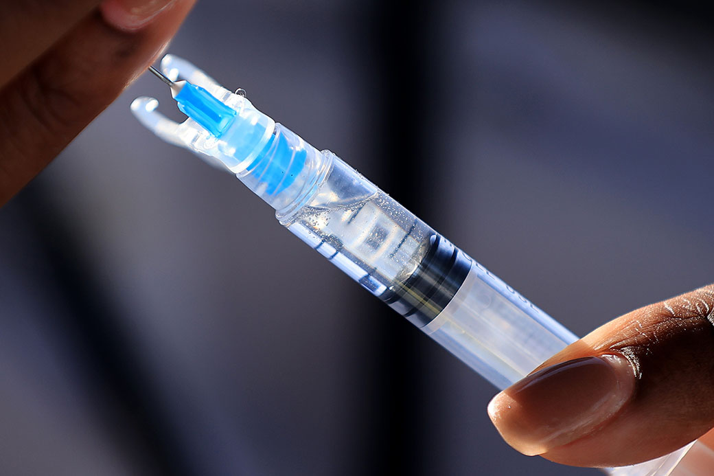 A nurse manager fills a syringe with a dose of a coronavirus vaccine during a walk-up clinic in Washington, May 2021. (Getty/Chip Somodevilla)