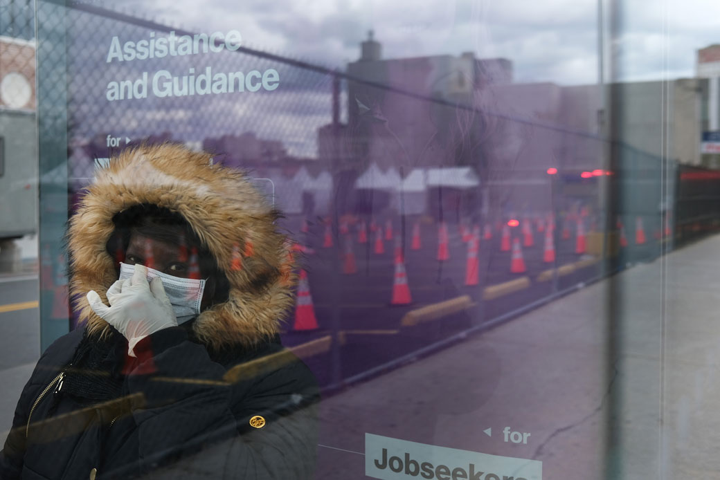 A woman waits for a bus near a COVID-19 testing site in Brooklyn, New York, on April 10, 2020. (Getty/Spencer Platt)