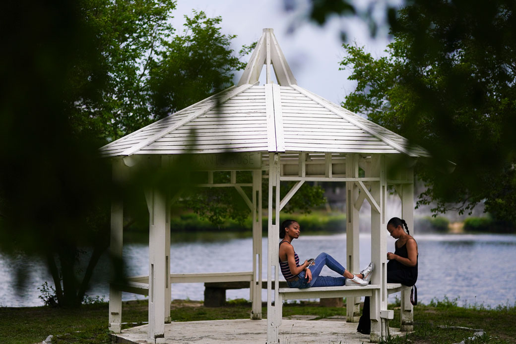A mother and her daughter sit in Briscoe Park in Snellville, Georgia, June 2021.