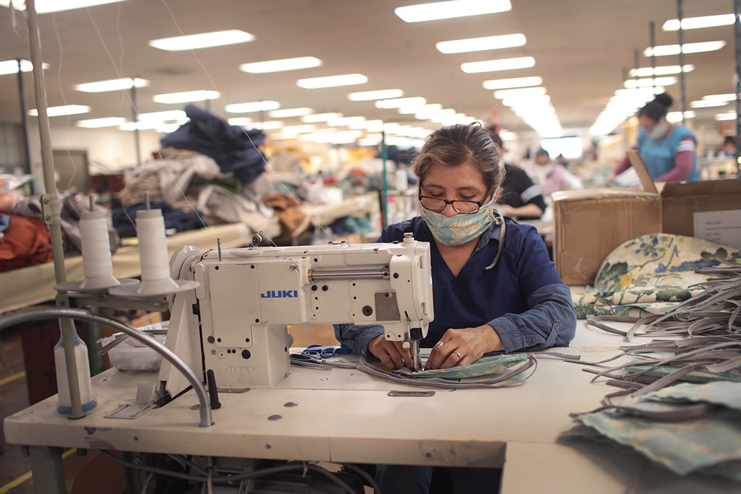 Workers at a furniture manufacturer sew personal protective equipment (PPE) on March 30, 2020, in Illinois. (Getty/Scott Olson)