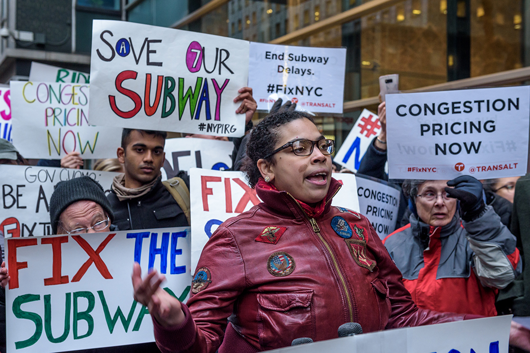 Transit riders, elected officials, and advocates, including Access-a-Ride organizer Eman Rimawi, rally outside Cuomo's office