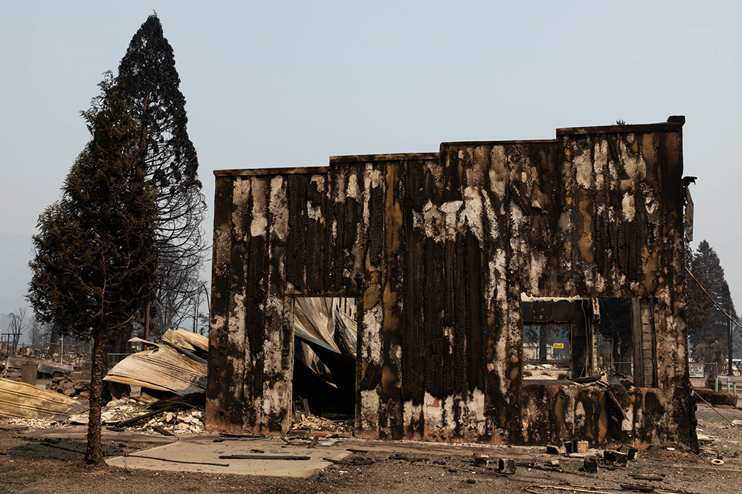 A building that burned in the Dixie Fire remains standing amid rubble on August 8, 2021, in Greenville, California. (Getty/Maranie R. Staab)