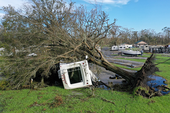 PARADIS, LOUISIANA - AUGUST 31: In this aerial photo, an RV that is flipped over sits under an uprooted tree in an RV park after Hurricane Ida on August 31, 2021 in Paradis, Louisiana. Ida made landfall August 29 as a Category 4 storm southwest of New Orleans, causing widespread power outages, flooding and massive damage.  (Photo by Scott Olson/Getty Images)