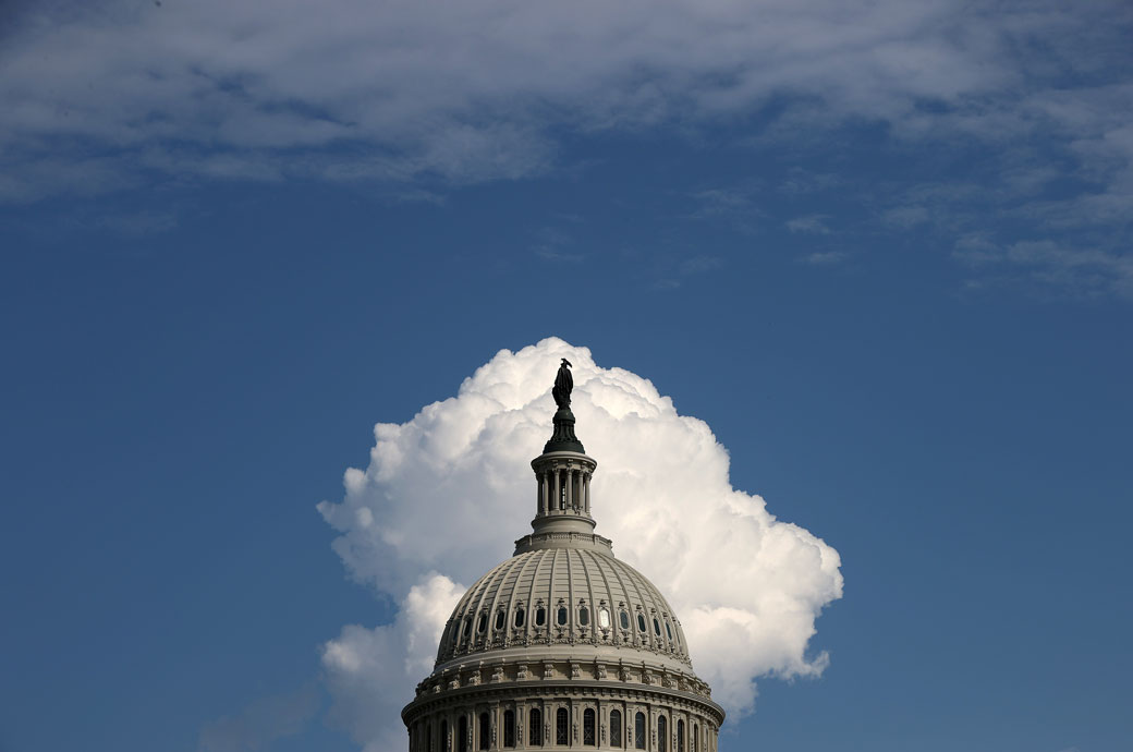 A cloud rises behind the U.S. Capitol, August 2021 (Getty/Chip Somodevilla)