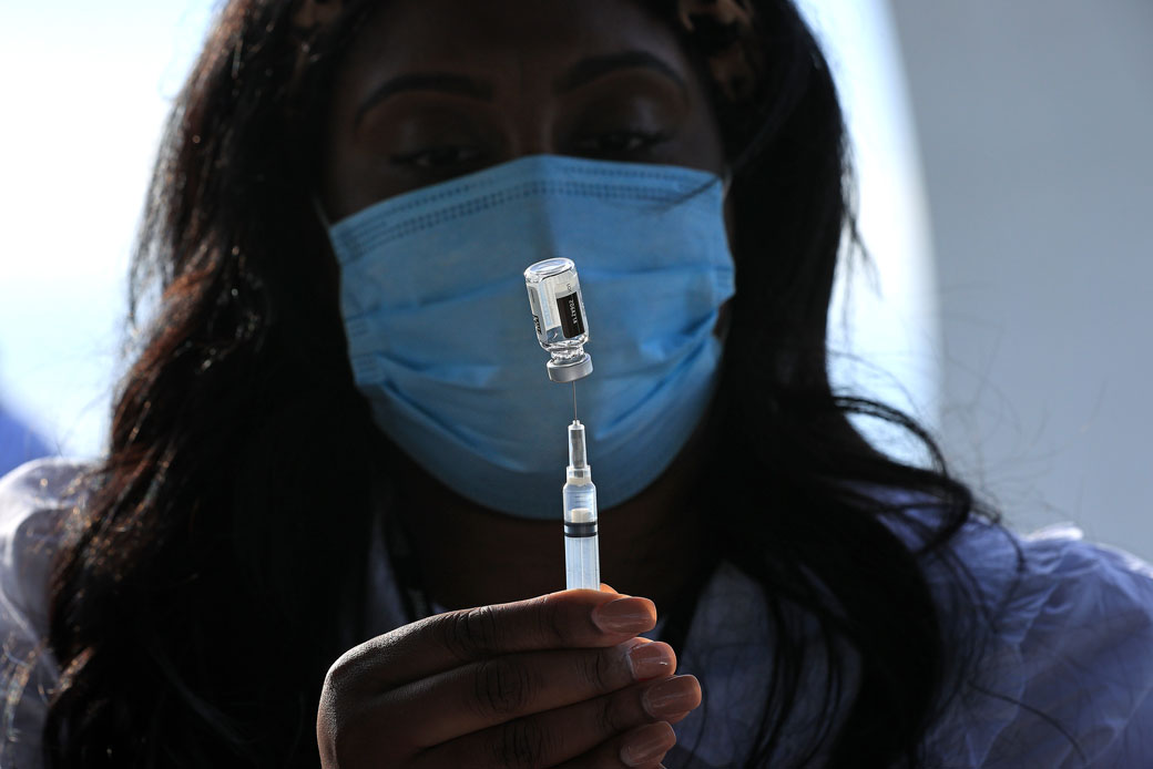 A nurse manager in Washington, D.C., fills a syringe with a dose of the Johnson & Johnson COVID-19 vaccine during a walk-up clinic at the John F. Kennedy Center for the Performing Arts on May 6, 2021. (Getty/Chip Somodevilla)