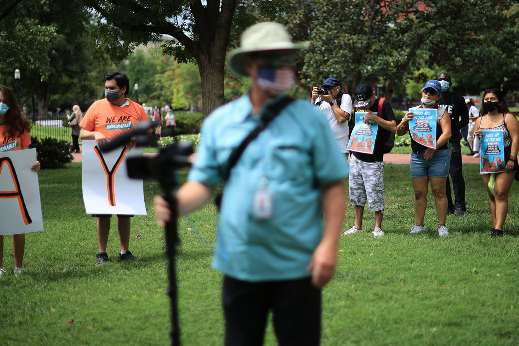 Activists stand in Lafayette Square, across from the White House, in an effort to urge Congress and the Biden administration to create a pathway to citizenship for millions of immigrants on August 17, 2021, in Washington, D.C.