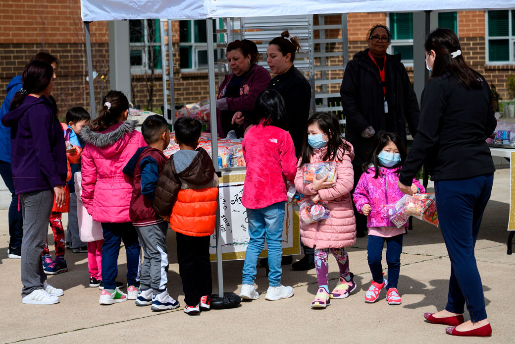 Children pick up free lunch at a middle school in Arlington, Virginia, March 2020. (Getty/Andrew Caballero-Reynolds/AFP)