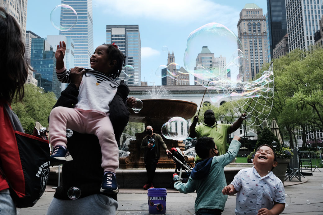 Children and adults play with bubbles at Bryant Park in Manhattan, New York, on May 4, 2021. (Getty/Spencer Platt)