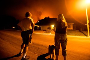 People watch as the Bobcat Fire burns land in Monrovia, California, on September 15, 2020.
