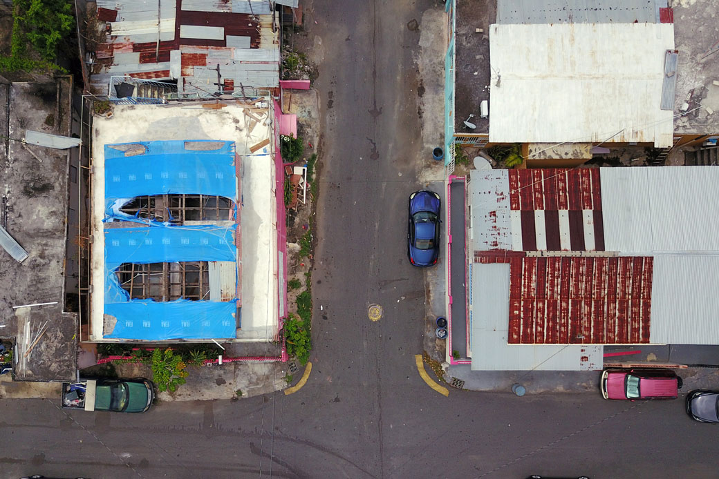 A blue tarp that was used to protect the roof of a home damaged by Hurricane Maria in 2017 shows wear and tear two years later in September 2019 in San Juan, Puerto Rico.