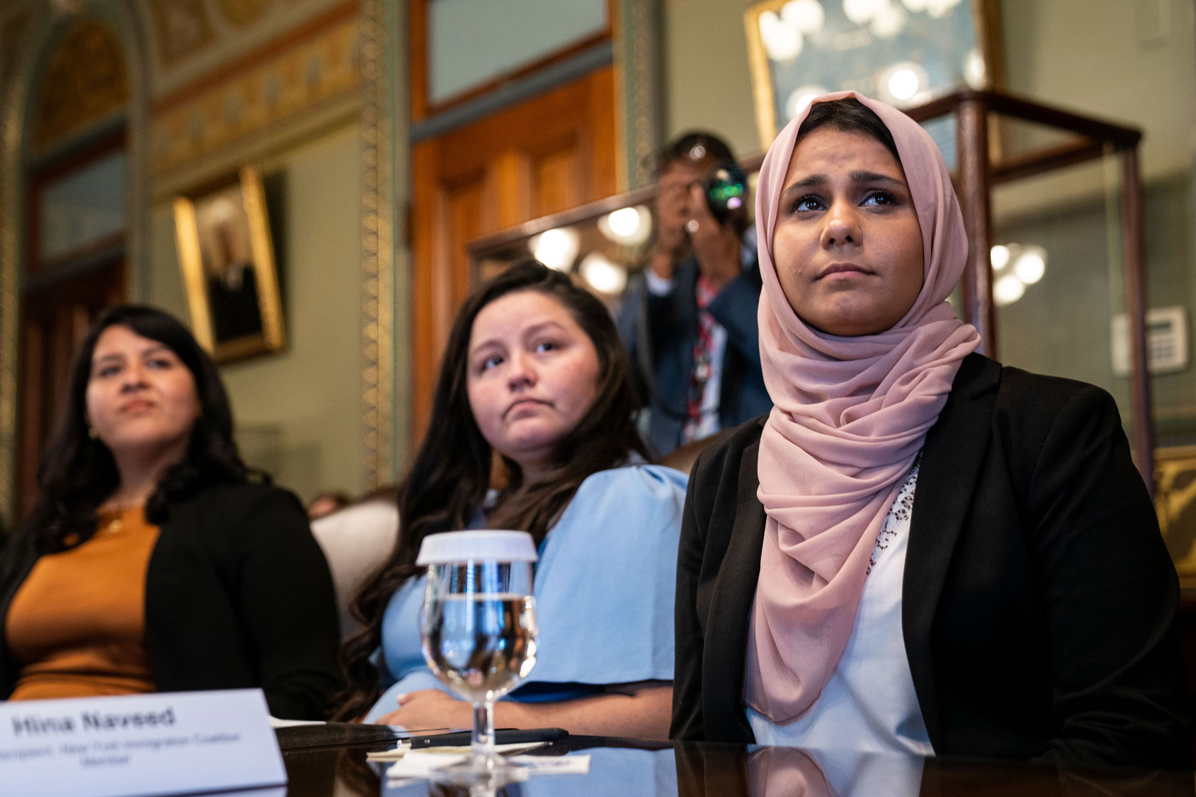 DACA recipients and immigrant rights leaders sit at a table in the Roosevelt Room with Vice President Kamala Harris.