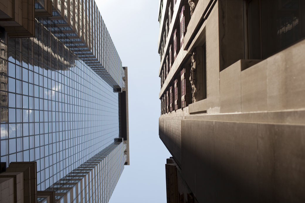 Two buildings face each other along a narrow street in the Wall Street area of New York City, June 2012. (Getty/Robert Nickelsberg)