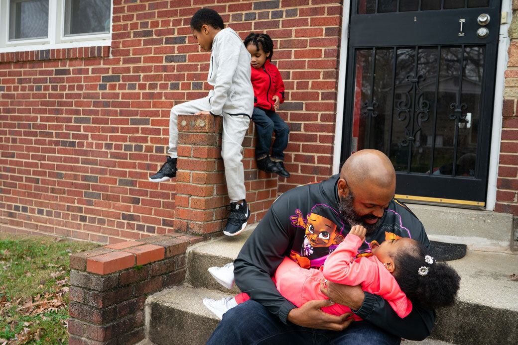 A man and his three children on porch