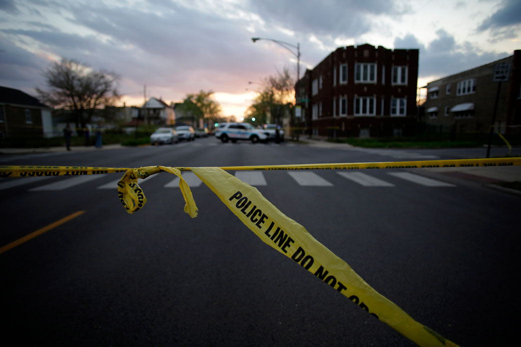 Police crime tape is displayed at a scene where two people were shot in a Midwestern city, April 2016.