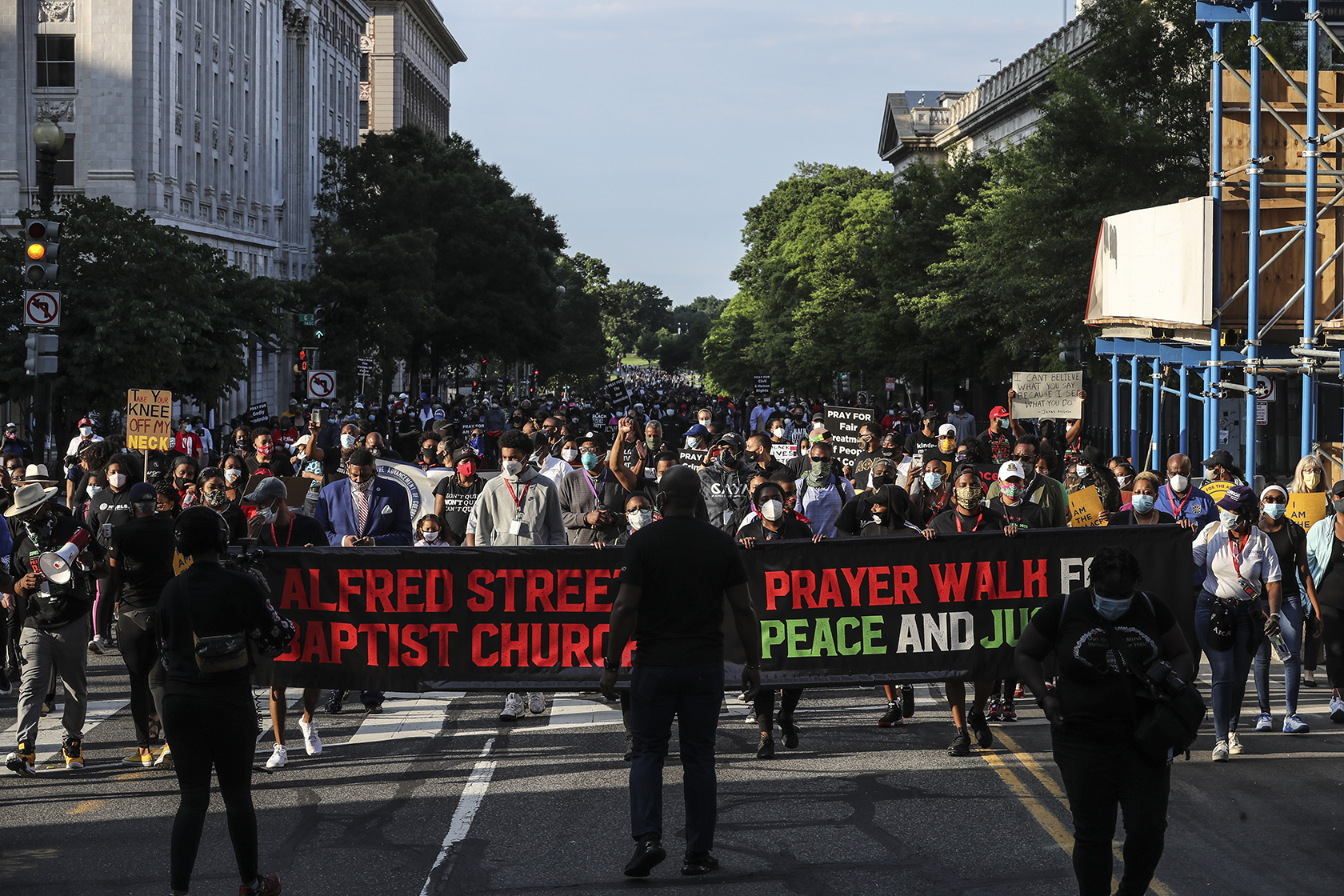 Hundreds march in Washington with event banner in front