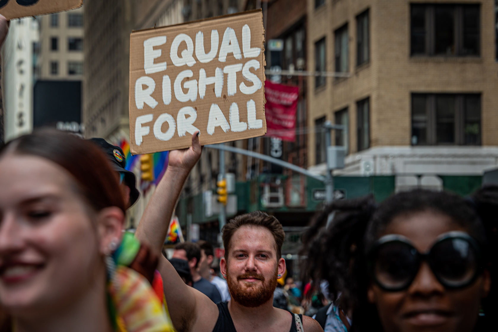 A participant is seen holding a sign reading 