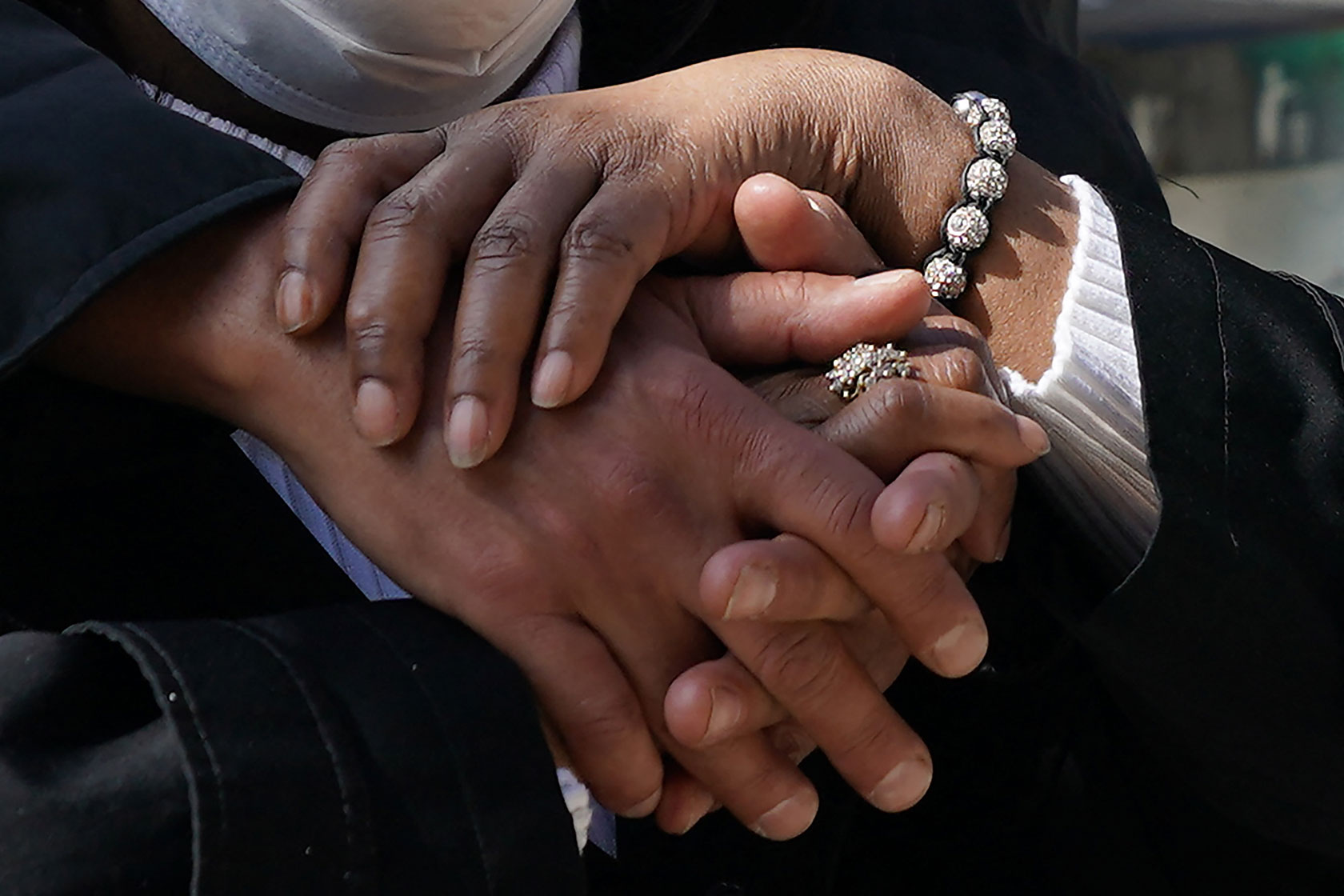 Yvette Nesbit and Lorenzo Laroc hold hands as they gather near the Cathedral of St. John the Divine in New York for a Service of Prayer and Witness Against Anti-Asian Violence on March 23, 2021.