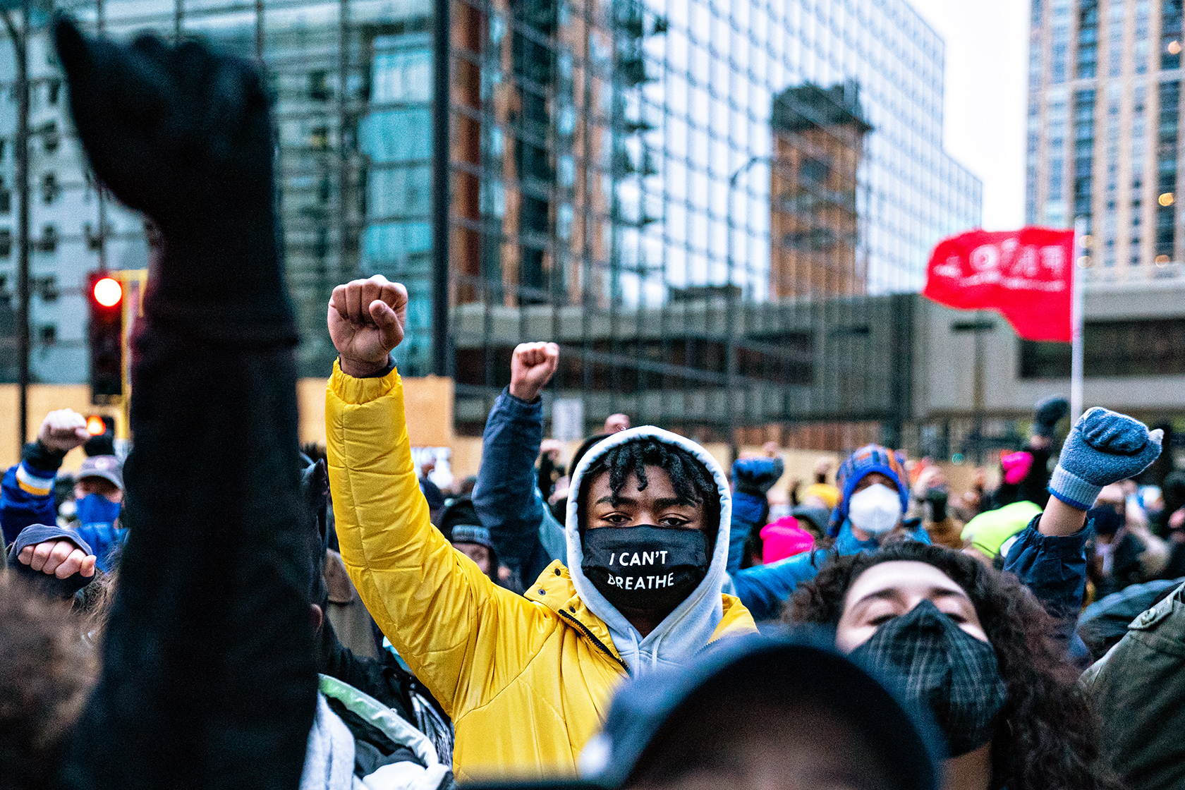 A group of people holding their fists in the air, man in foreground