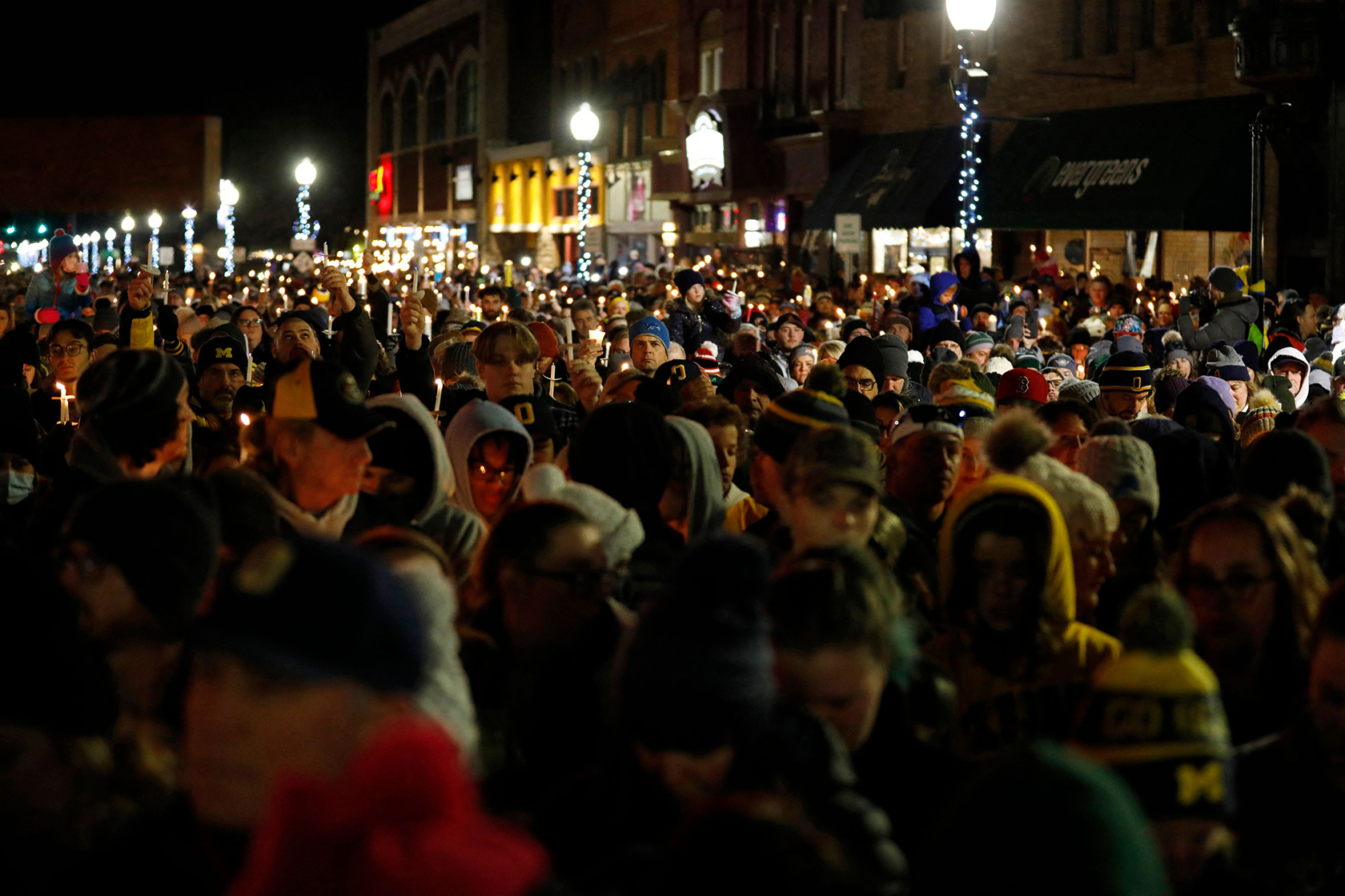 A crowd at a nighttime candlelight vigil