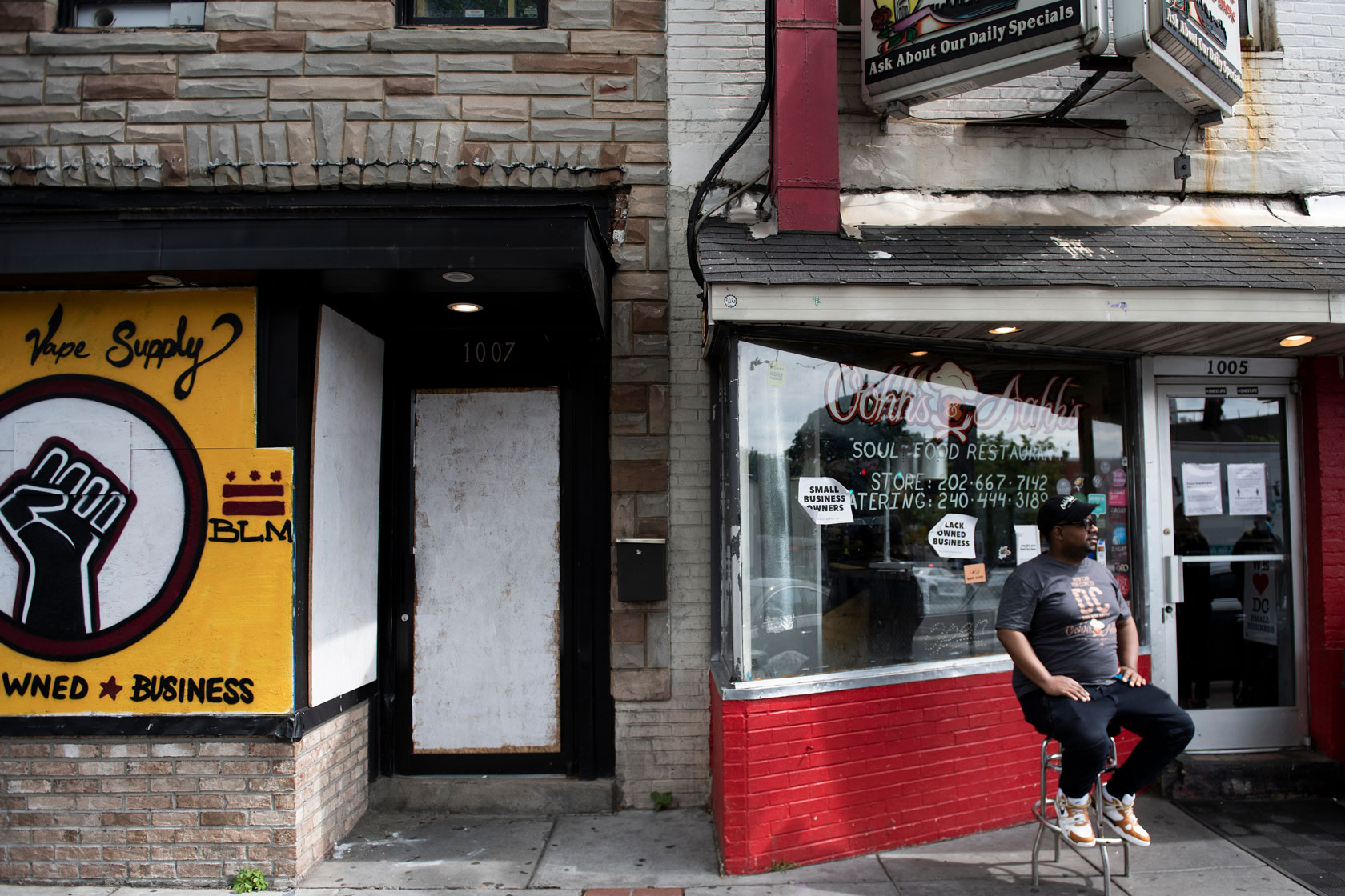 A chef sits in front of his restaurant in Washington, D.C., in June 2020.