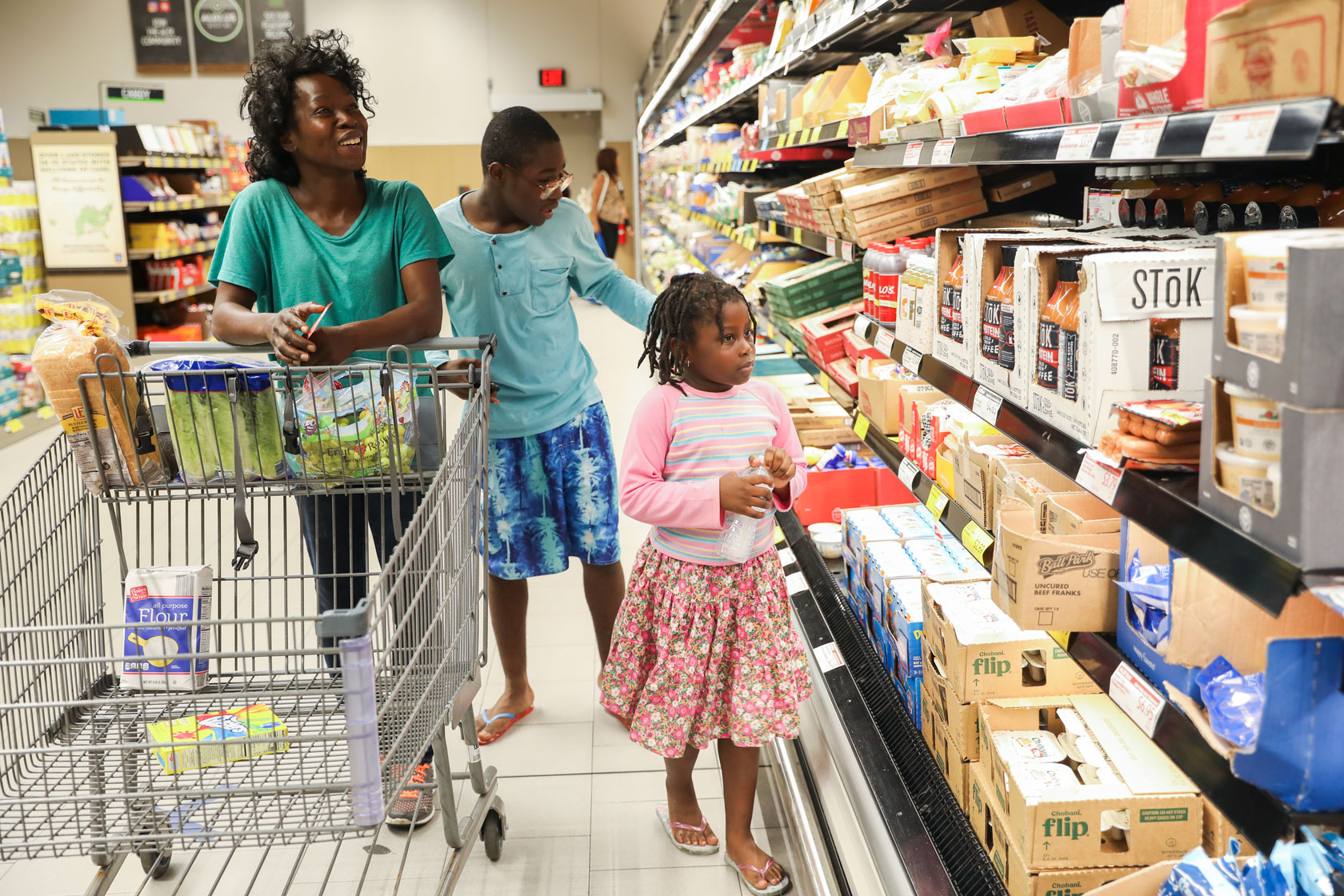 A woman and her two children shop for groceries in Kissimmee, Florida.