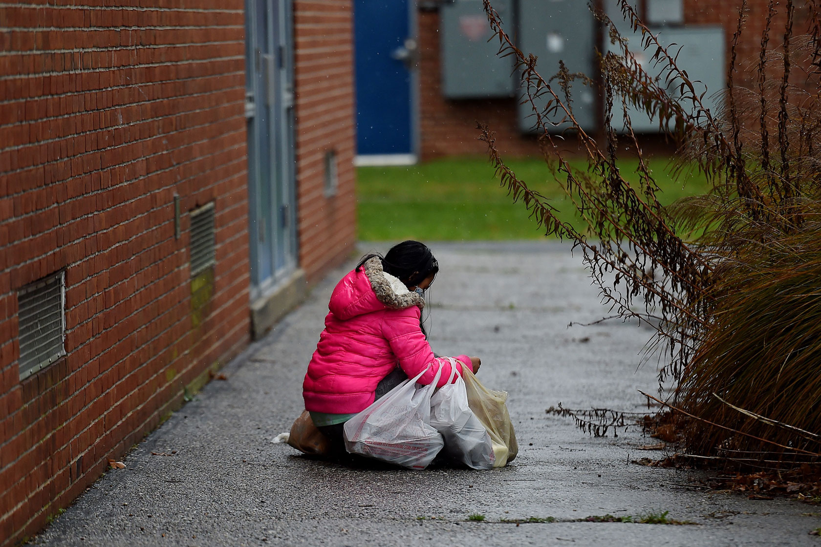 Woman alone on street with bags of food