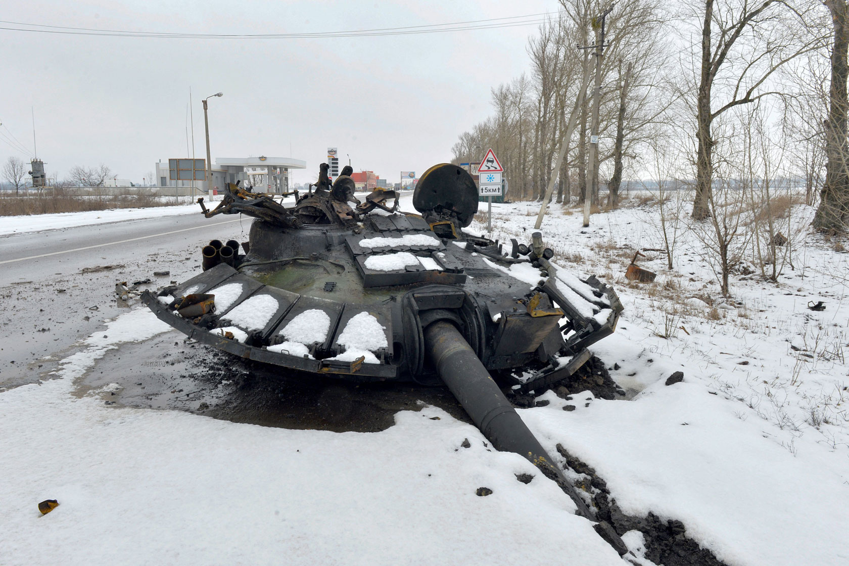 A fragment of a destroyed Russian tank is seen on the roadside on the outskirts of Kharkiv.