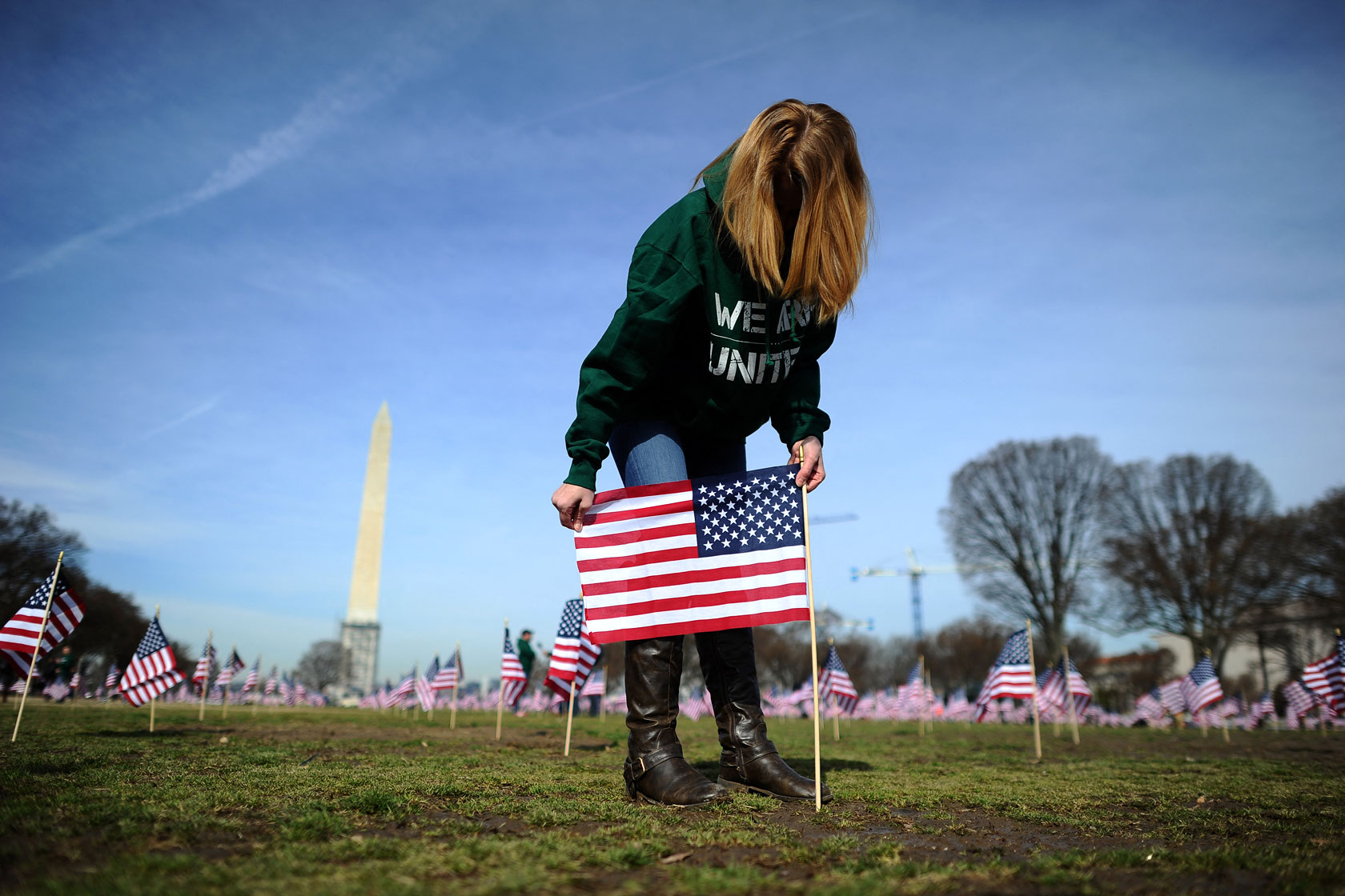 A war veteran sets up flags on the National Mall.