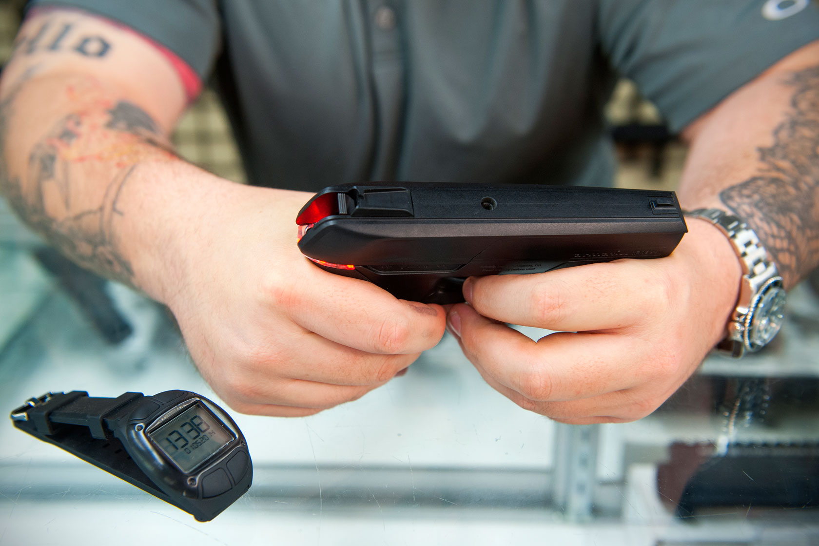 Gun store owner demonstrates a smart gun.