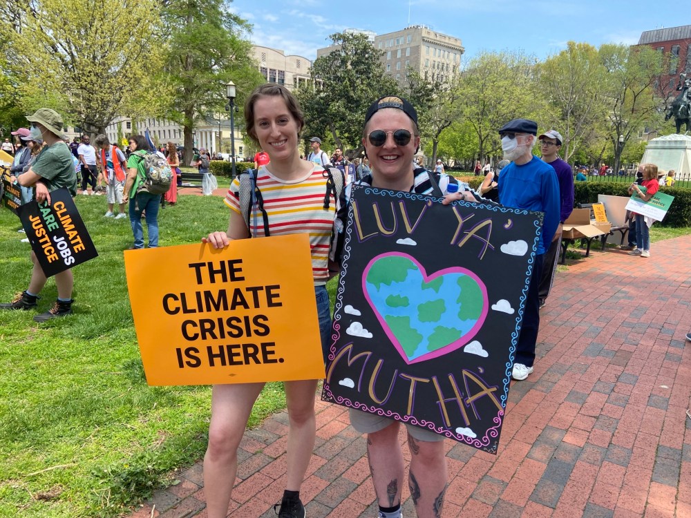 Emily Donahue (left) holds a sign that reads: 