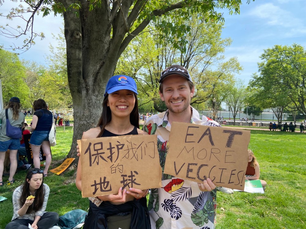Yao Hemming (left) and Neville Hemming (right) hold signs during the