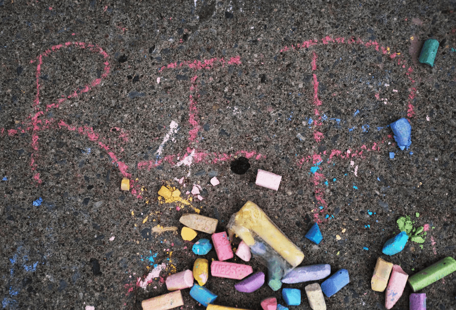 RIP written on the sidewalk in chalk at the memorial for the shooting victims outside of Tops market on May 20, 2022 in Buffalo, New York