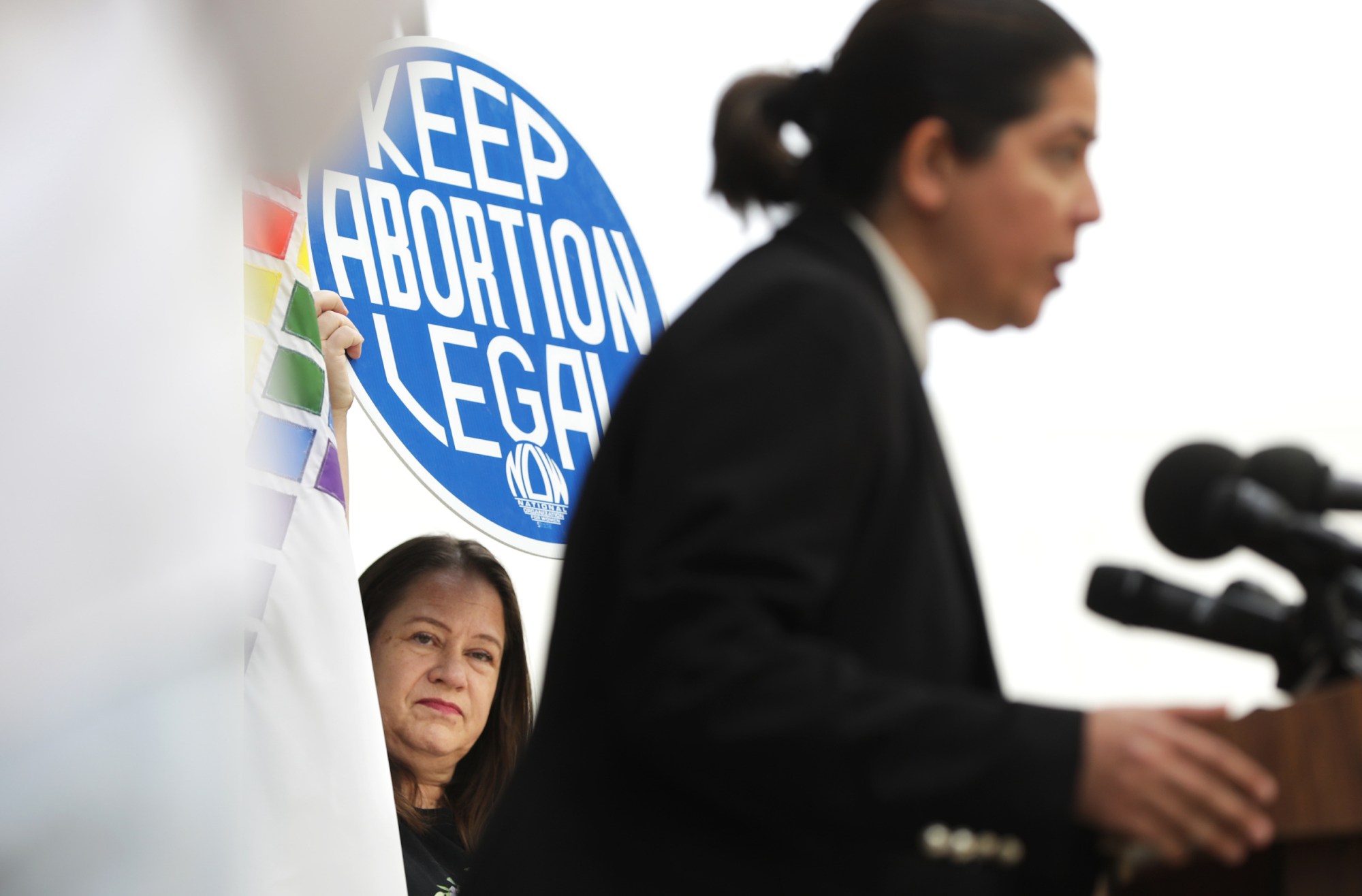 WEST HOLLYWOOD-CA-MAY 3, 2022: Karen Eyres, President of Hollywood NOW, at left, shows support for reproduction rights as West Hollywood Mayor Pro Tempore Sepi Shyne speaks at a news conference in response to a leaked draft of the Supreme Court's opinion to overturn Roe v. Wade, at City Hall in West Hollywood on Tuesday, May 3, 2022.