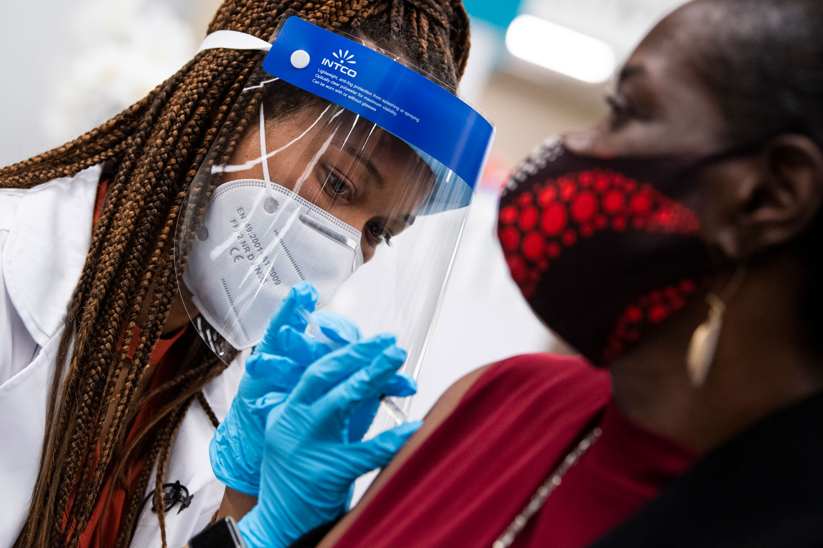 A doctor administers a Pfizer COVID-19 vaccine booster shot.