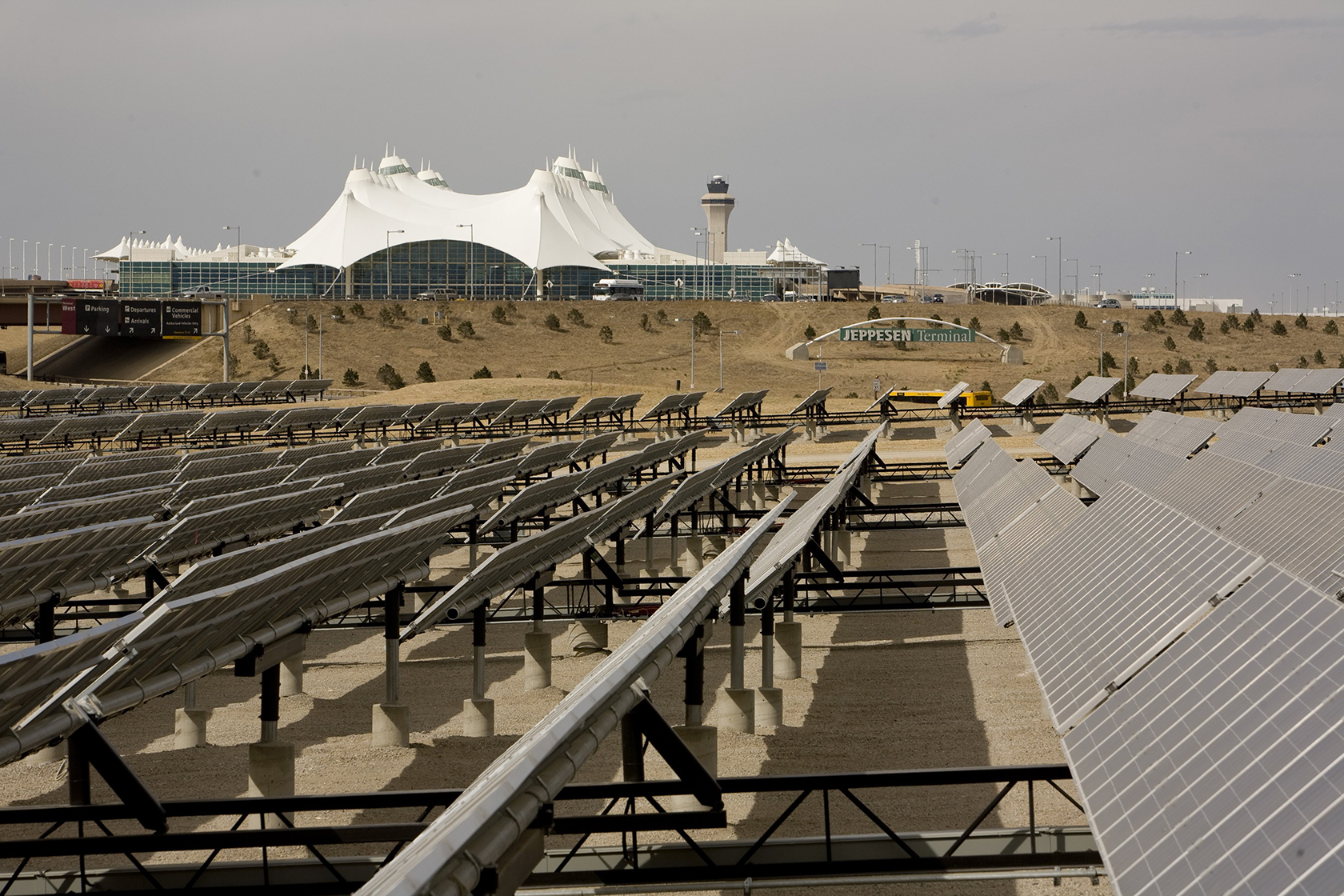 Solar panels foregrounded in photo of Denver International Airport