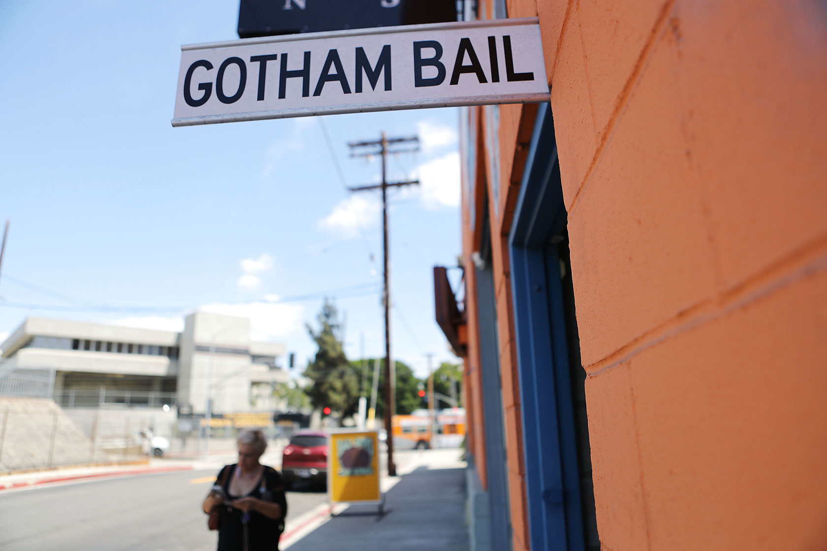 A sign attached to a storefront reads