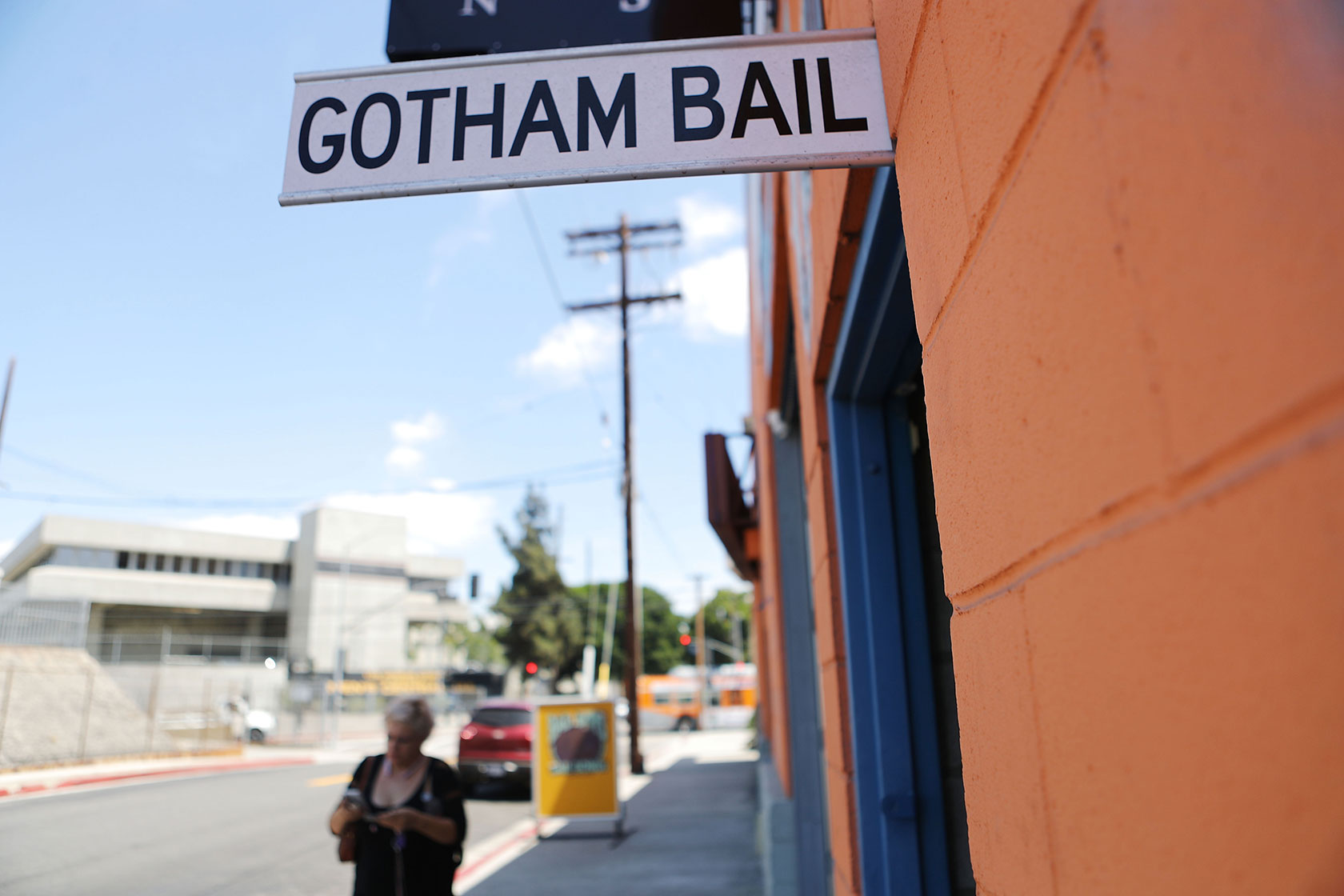 A sign attached to a storefront reads 