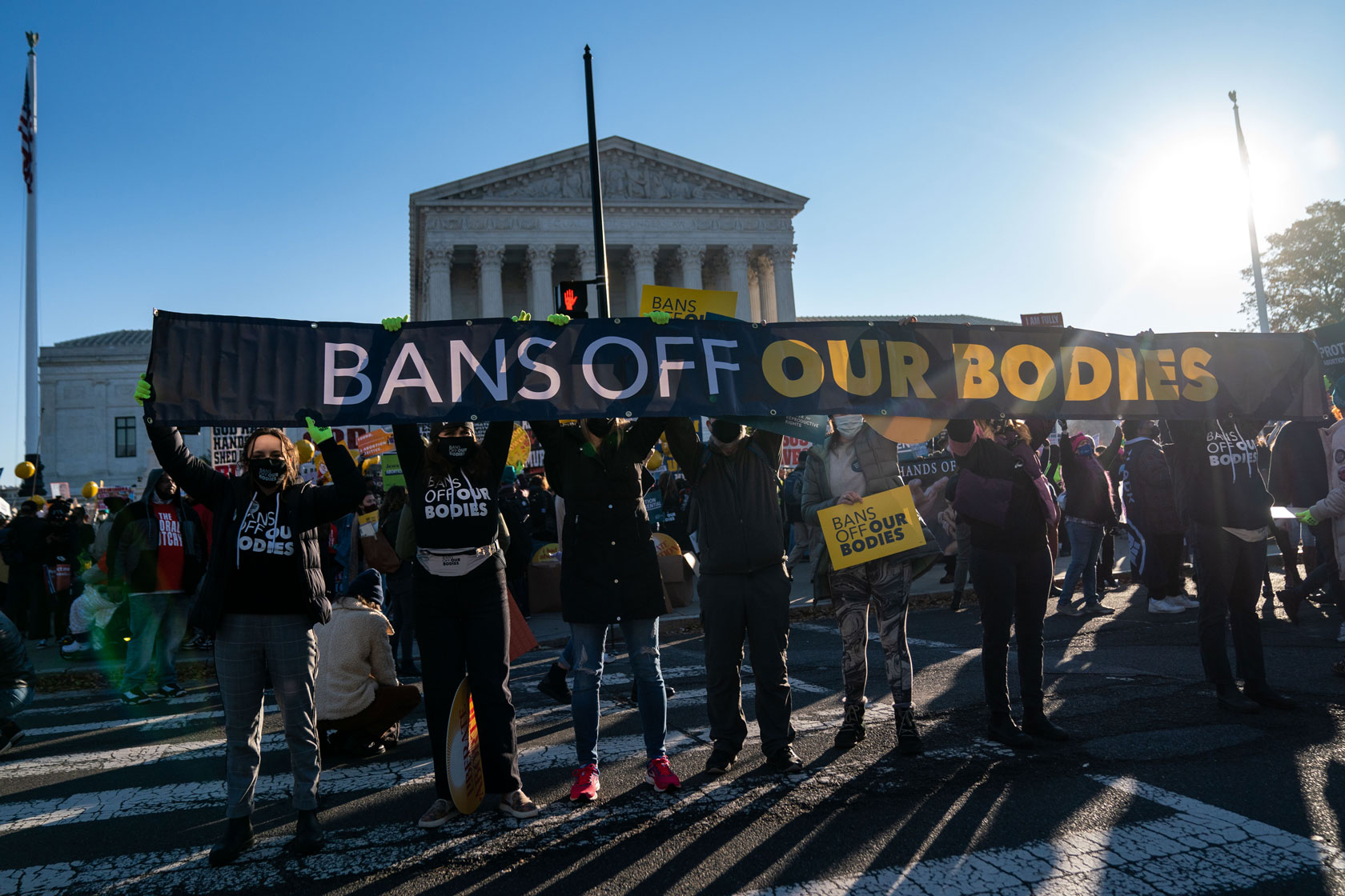 Abortion rights advocates holding a large sign that reads